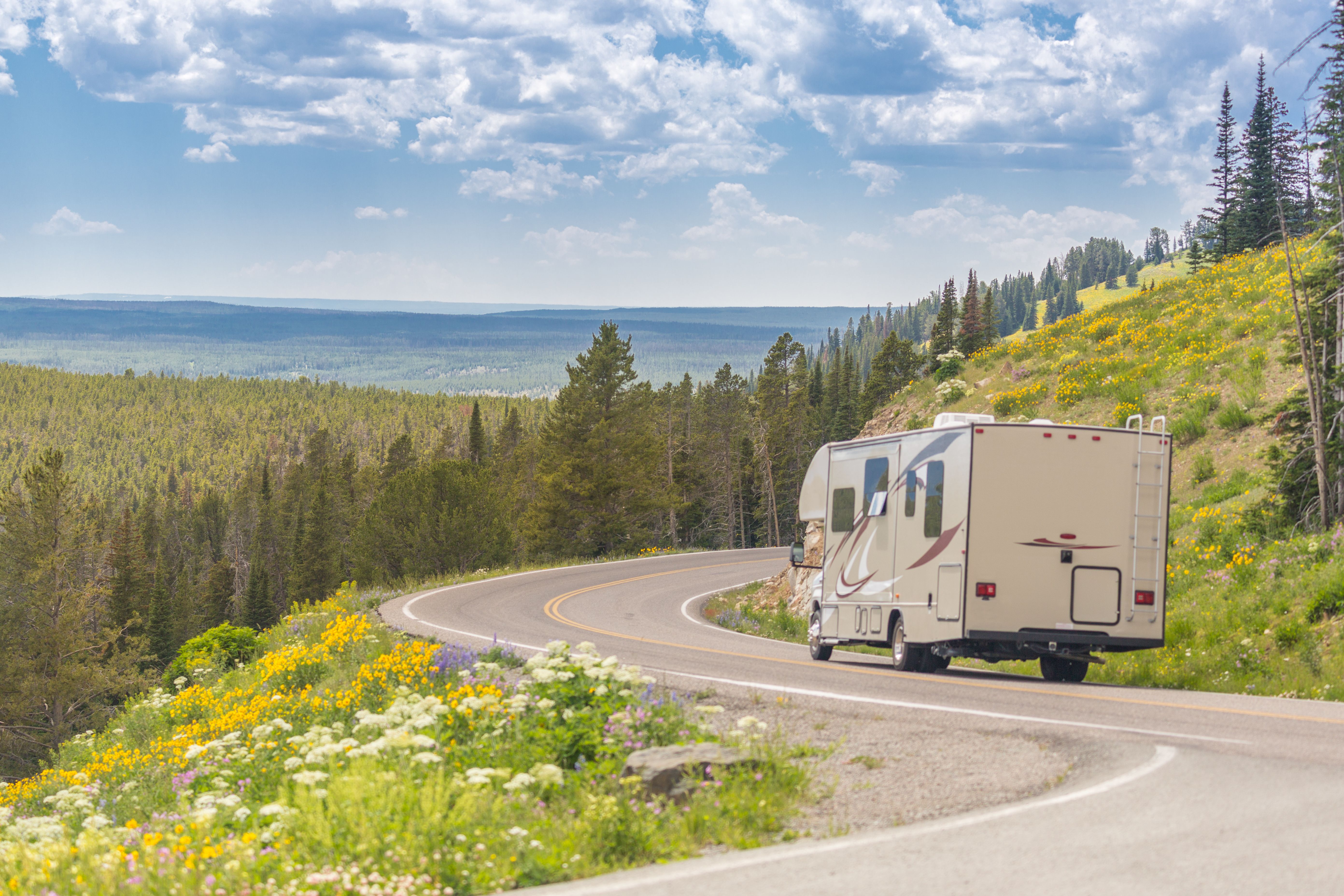 camper-driving-down-road-in-the-beautiful-countrys